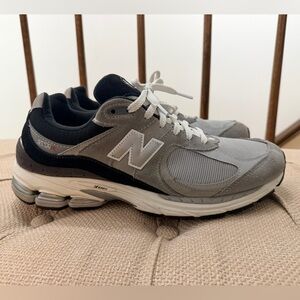 Preowned New Balance Men's 2002R Gray and Black Sneakers in good condition.
